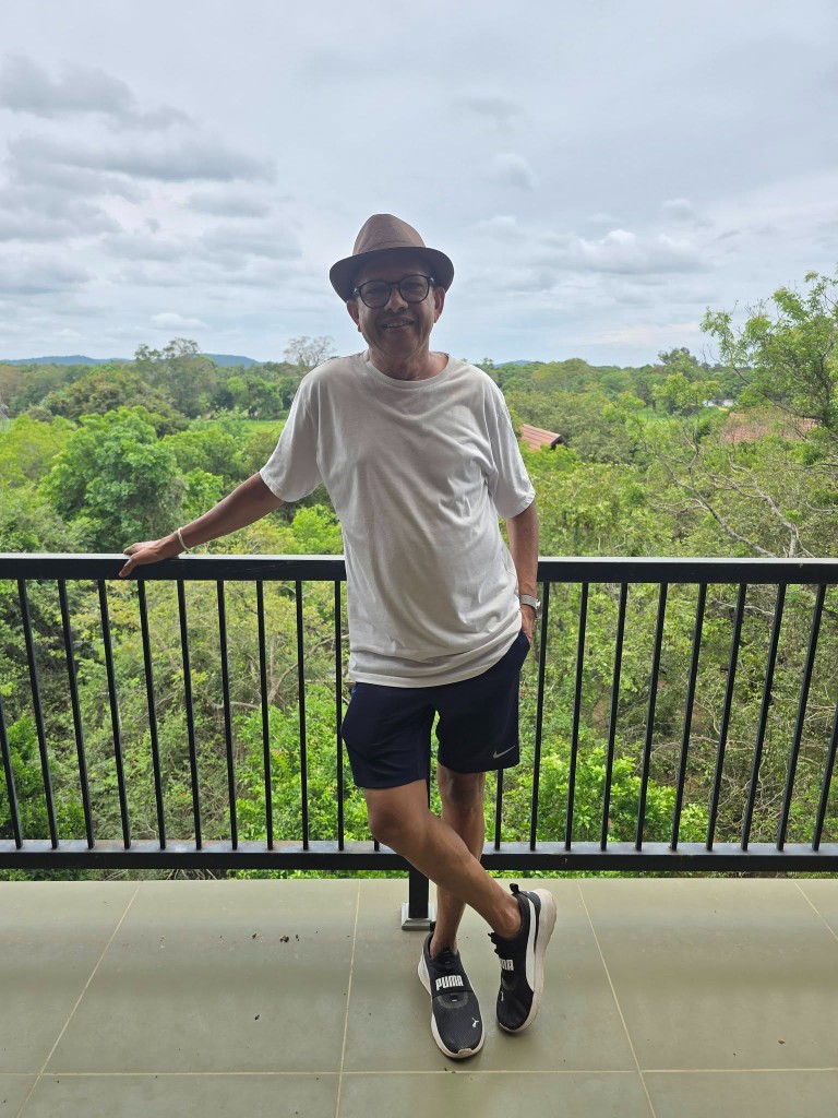 Ariya Gallege on a balcony overlooking the forest